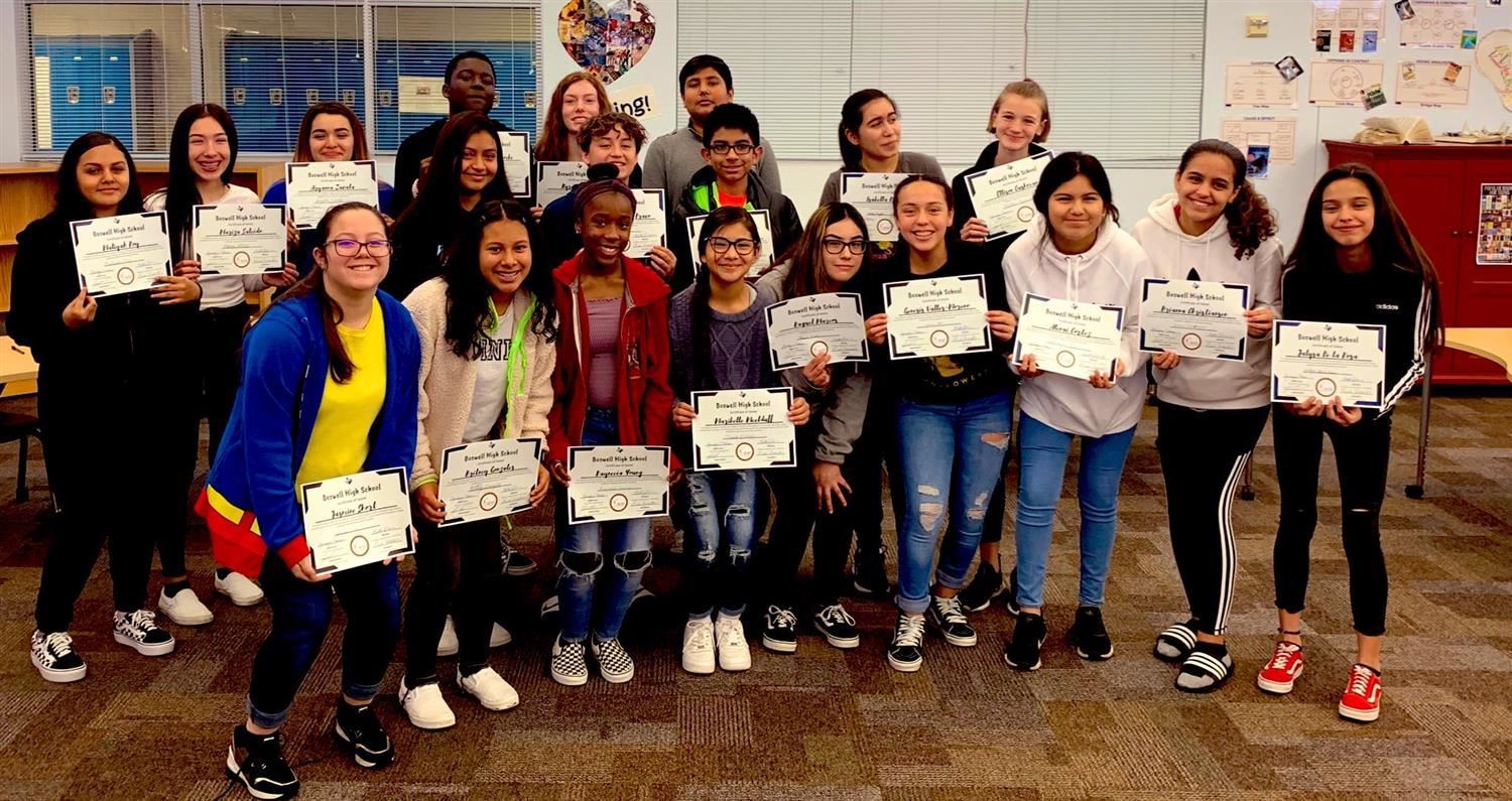 Wayside Middle School students smile and hold certificates